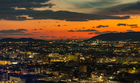 A picture of the city of Kyoto at sunset, with Osaka visible in the distance.