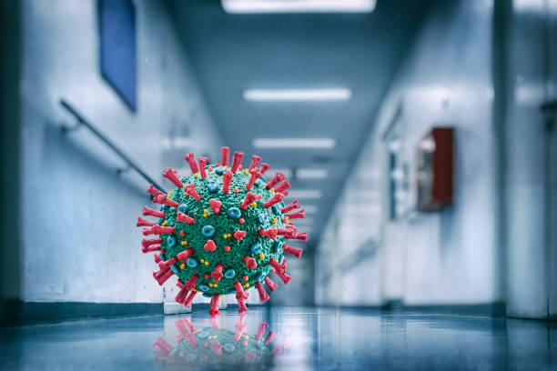 istock Corona Virus COVID-19 floating microscopic macro mockup in empty hospital 1213867033