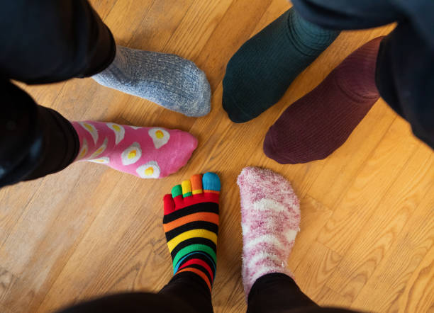 Funny family legs in mismatched socks stock photo