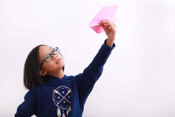 istock A girl playing with paper plane 1213868746