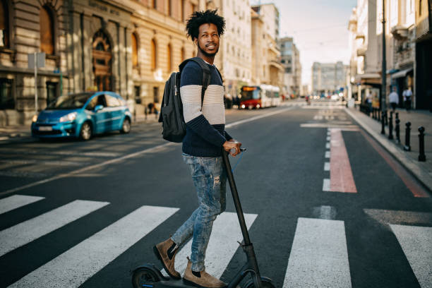 istock Young man ridding electric scooter 1213868854