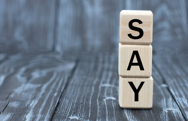 istock concept word SAY on cubes on a beautiful gray blue background 1213870129