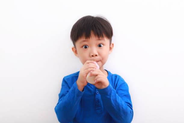 istock Happy little boy drinking yogurt drink. 1213870200
