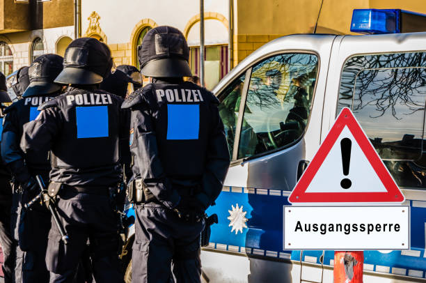 istock Police curfew warning sign in german 1213870401