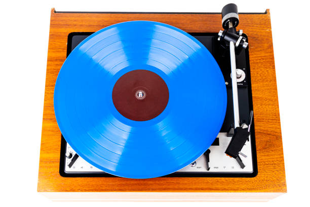 istock Vintage turntable with a blue vinyl isolated on white 1213870421