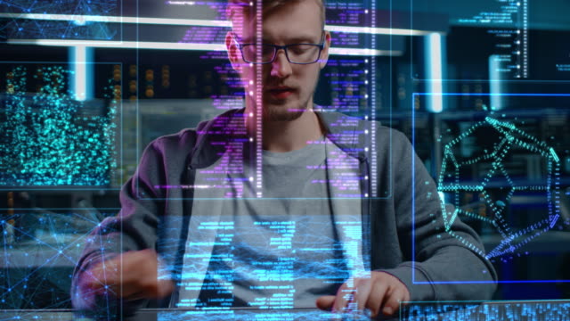 Software Programmer Working on Computer with Neural Networking, Machine Learning, Big Data, Artificial Intelligence. Coding Language Projection Reflects on His Face. POV Portrait Camera