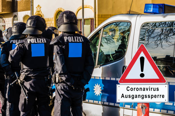 istock Corona virus curfew warning sign police control in german 1213871026