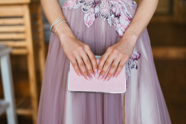 istock hands holding a pink clutch 1213871134