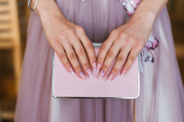 hands holding a pink clutch hands of a girl holding her glitter pink clutch clutch bag stock pictures, royalty-free photos & images