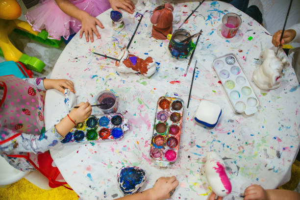 istock kids playing with watercolor paints and brushes 1213871596