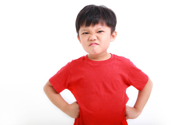 istock Angry boy with hands on hips isolated on white background 1213872926