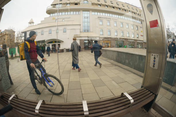 Moscow, Russia - March 20, 2020: Fish-Eye. Moscow cityscape in spring sunset. Sukharevskaya subwway station (Moscow Metro). A few people on the street. Coronavirus Pandemic lifestyle of the big city