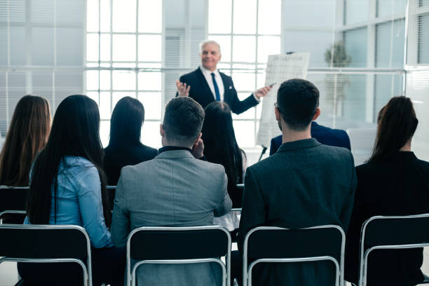 istock rear view. company employees applauding at a work meeting 1213877411
