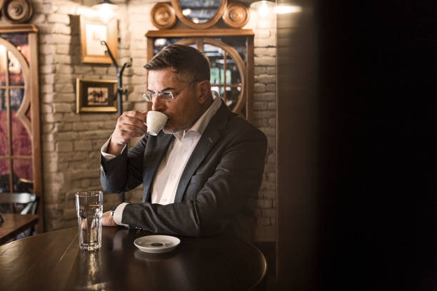 istock Businessman in cafe on a coffee break enjoin coffee 1213877499