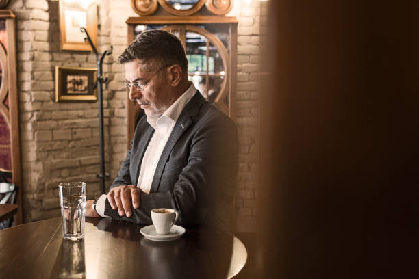 istock Businessman in cafe on a coffee break enjoin coffee in peace 1213877522