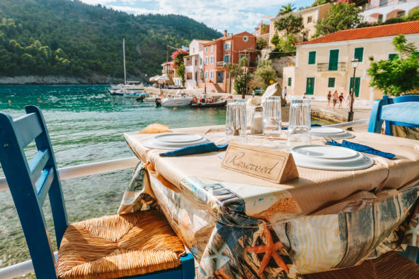 reserved table in greek tavern in assos fishing village, kefalonia island, greece - dining nautical vessel recreational boat europe imagens e fotografias de stock