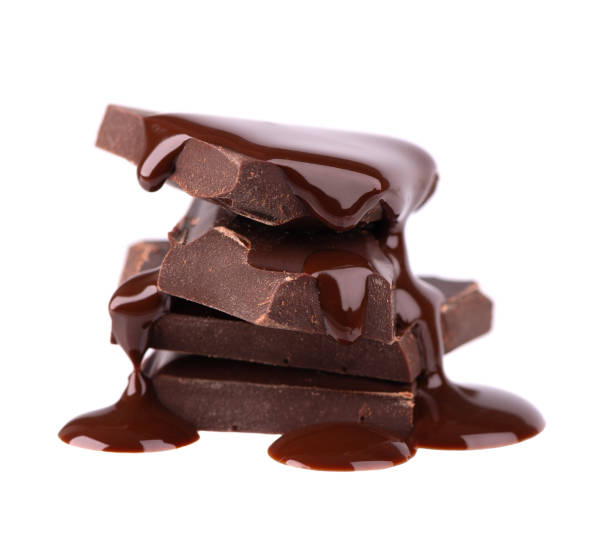 istock Chocolate pieces stack and chocolate syrup isolated on white background. Close up. 1213879845