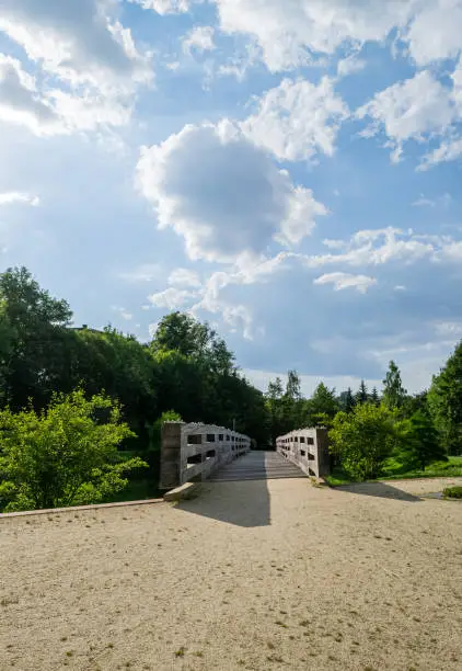 wooden bridge in an empty city park as a result of corona virus or Covid-19 in the spring