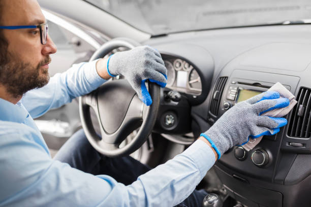 istock Car wash worker polishing car interior. 1213881010