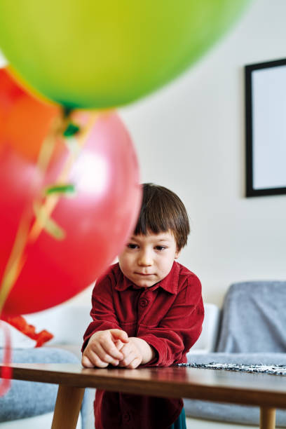 istock Cute child playing colorful hellium balloons at home. 1213882137