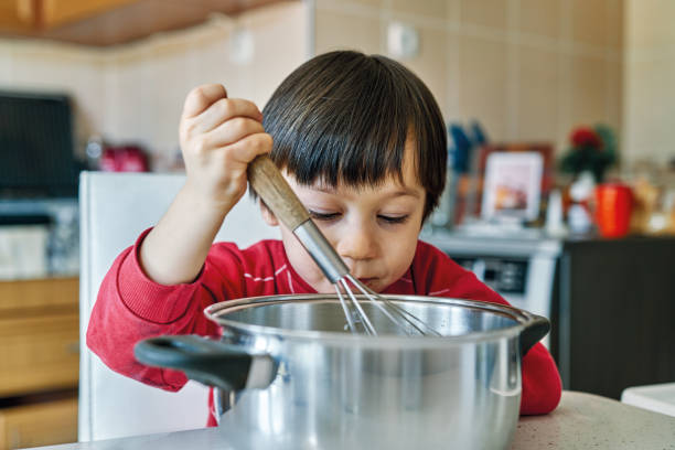 istock 2-3 years old child making cake at kitchen 1213882622