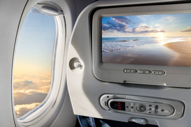 Concept of airplane travel to exotic destination Airplane window and multimedia screen with beautifu sunset viewl big island hawaii islands photos stock pictures, royalty-free photos & images