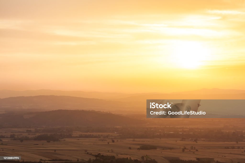 Dawn High angle view of idyllic agricultural fields and hills at sunset near Kragujevac, Serbia. Agricultural Field Stock Photo