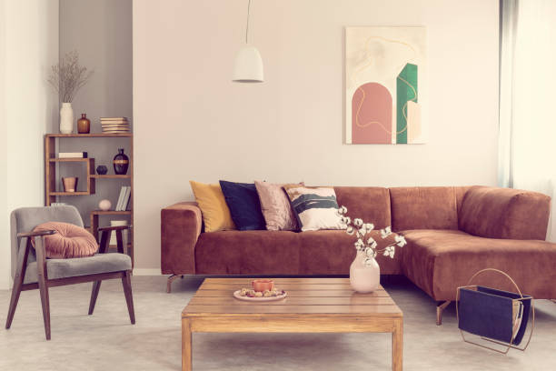 istock Comfortable brown velvet sofa with pillows in elegant living room interior 1213885069