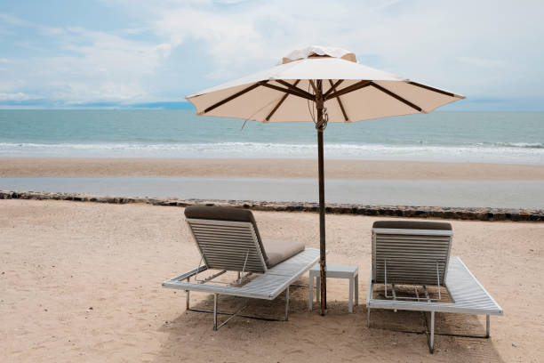 istock two chairs and umbrella on the beach 1213885535
