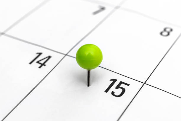 zielony przypięty pin w kalendarzu 15 dnia. - calendar tax april day zdjęcia i obrazy z banku zdjęć