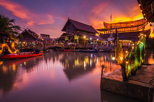 Sunset at famous Pattaya Floating Market which has traditional rowing boats. Villagers sell traditional foods and souvenirs.