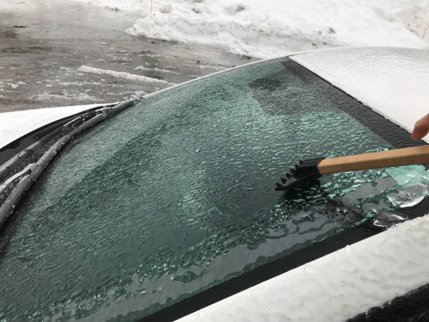 istock Close up on person removing ice on car 1213892826