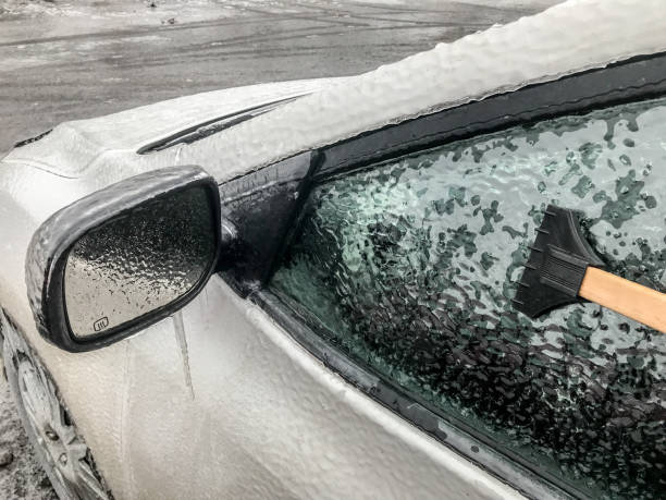 istock Close up on person removing ice on car 1213892860
