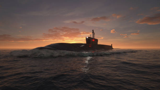 heavy atomic submarine in ocean at sunset - submarine imagens e fotografias de stock