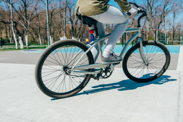 istock Close-up of woman's legs pedaling bicycle 1213893122