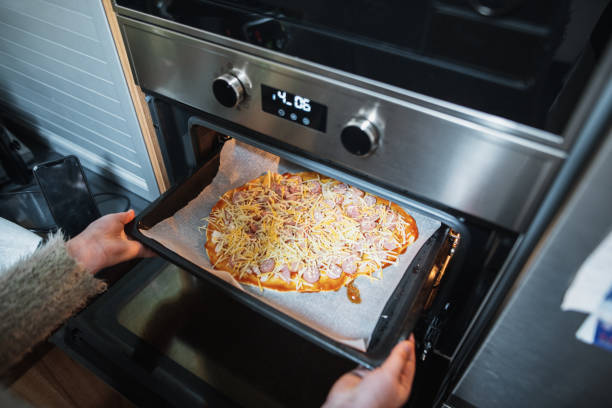 istock Putting a pizza in the oven 1213893308