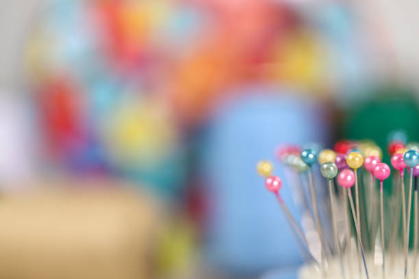 istock Colorful sewing needles close-up 1213896446