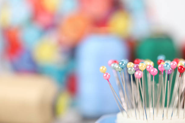 istock Colorful sewing needles close-up 1213896463