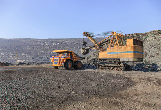 istock Excavator loads iron ore into a large dump truck 1213897851