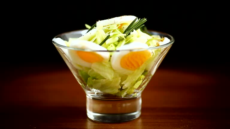 fresh spring salad with cabbage, lettuce and boiled eggs with rosemary and spices