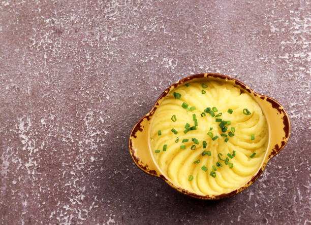 istock Mashed potatoes in a bowl on a dark background. Top view 1213899498