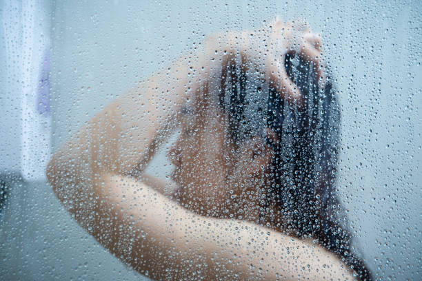 istock Woman showering 1213899548
