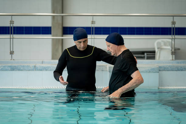 istock Senior man in the pool  doing exercises in hydrotherapy 1213902520