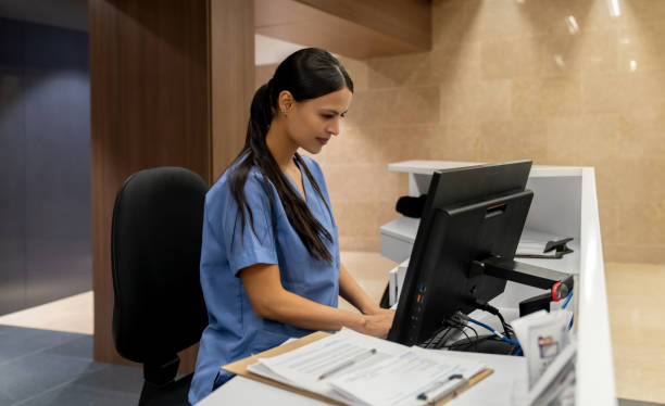 istock Nurse working on the computer at a nurse station 1213902657