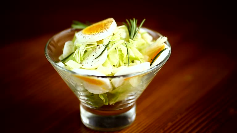 fresh spring salad with cabbage, lettuce and boiled eggs with rosemary and spices