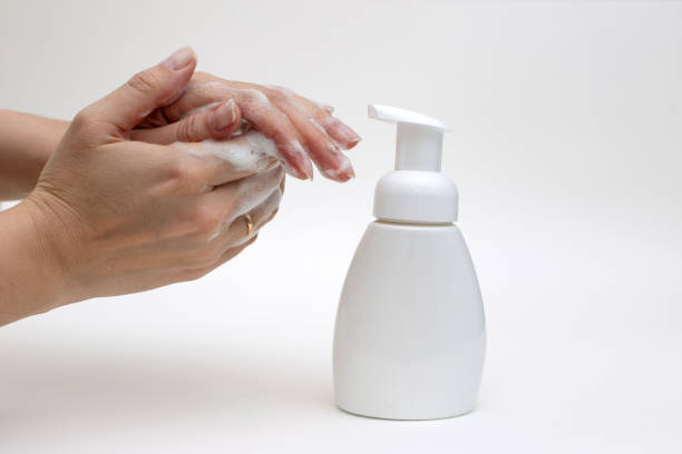 istock Hands on a white background in white foam from antibacterial soap 1213907797