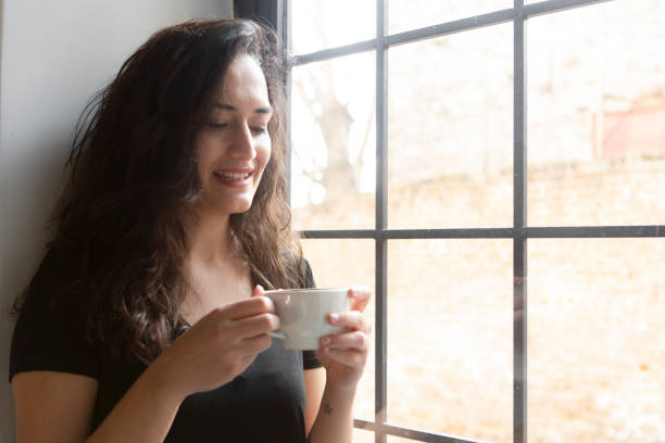 istock Thinking woman in front of the window 1213909055