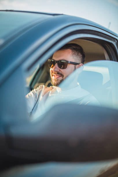 istock A man with sunglasses in the car 1213910317