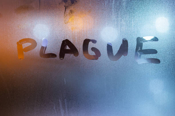 istock the word plague handwritten on sweat window glass surface at night 1213911036