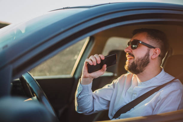 istock A man sings in a car 1213911108